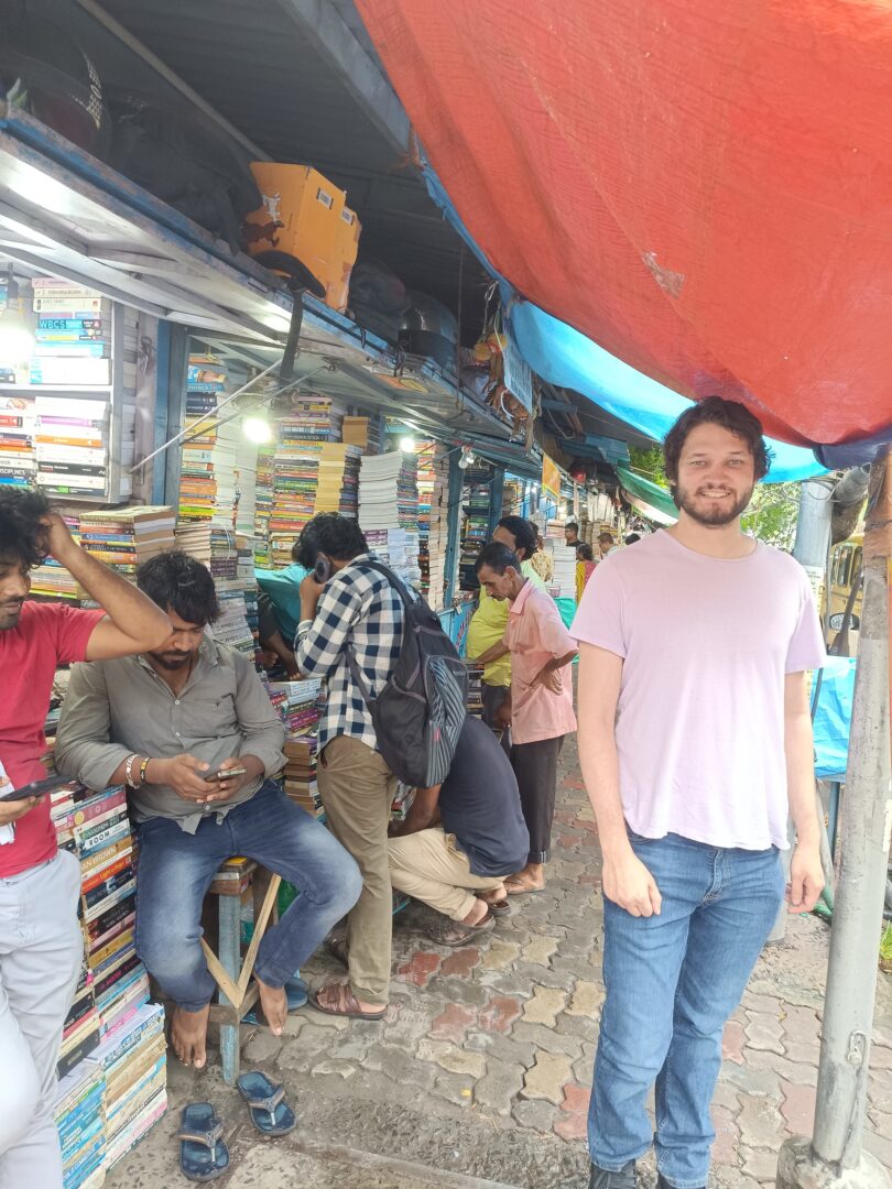 Busy street market filled with books.