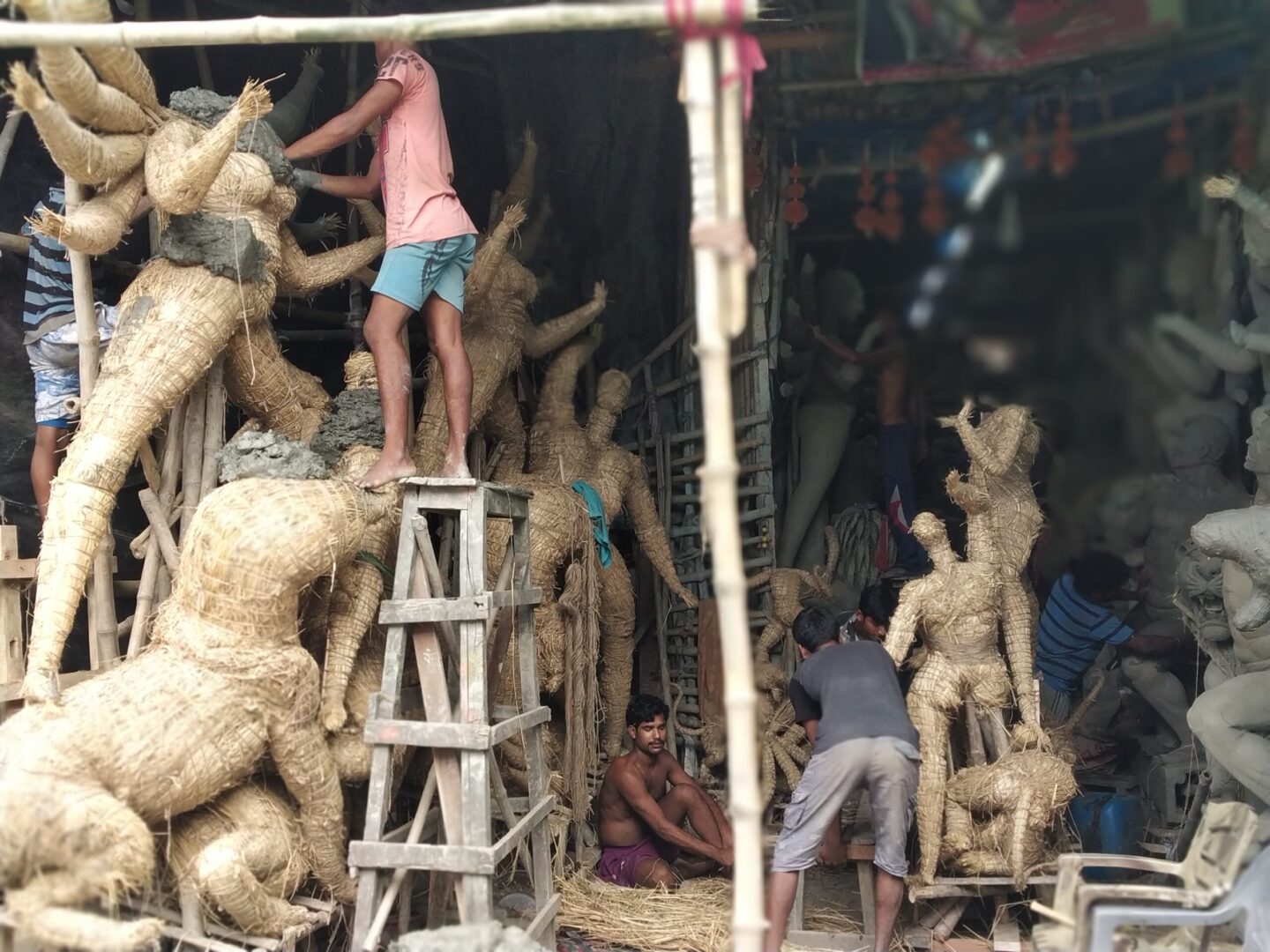 Artisans crafting traditional clay idols