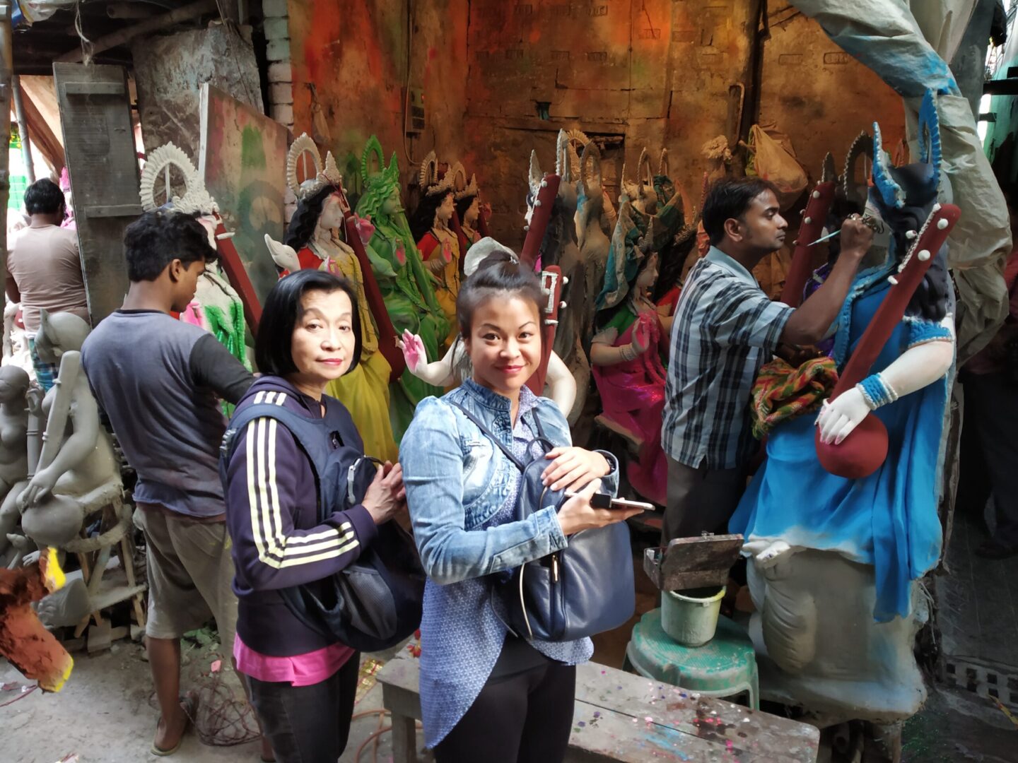 Artists preparing colorful clay idols.