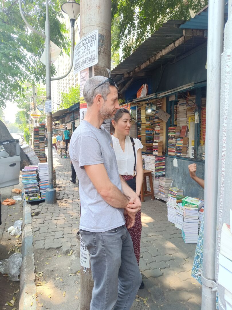 People browsing books on street
